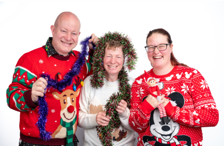 Darren and Dee, Directors of City Signs with Christmas jumpers and tinsel