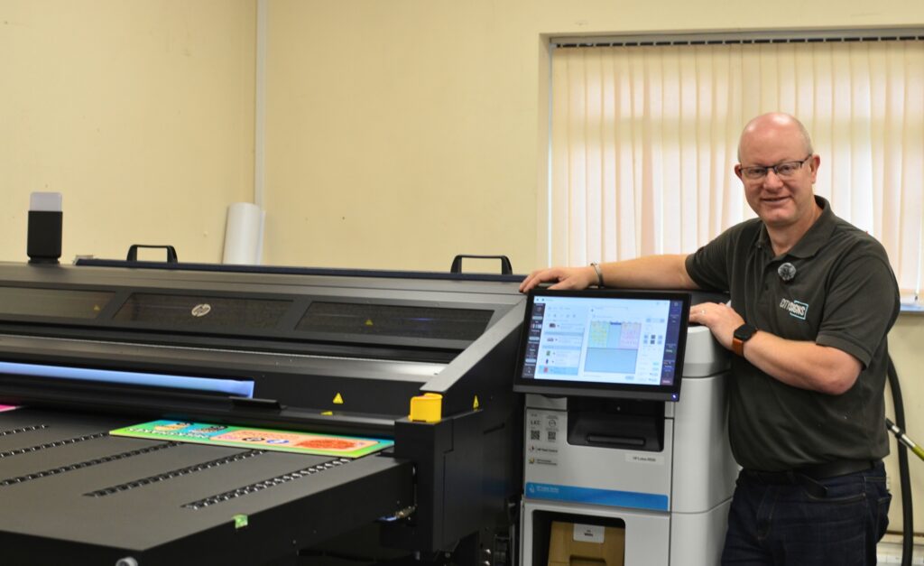Darren Wilkins, Managing Director of City Signs, stood with the new HP Latex R530